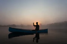 young-man-canoeing-canada-dawn-600nw-220881919.webp